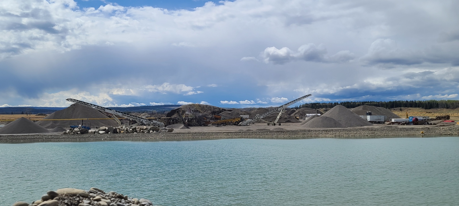 Excavators clearing right-of-way for lease and road construction in Alberta