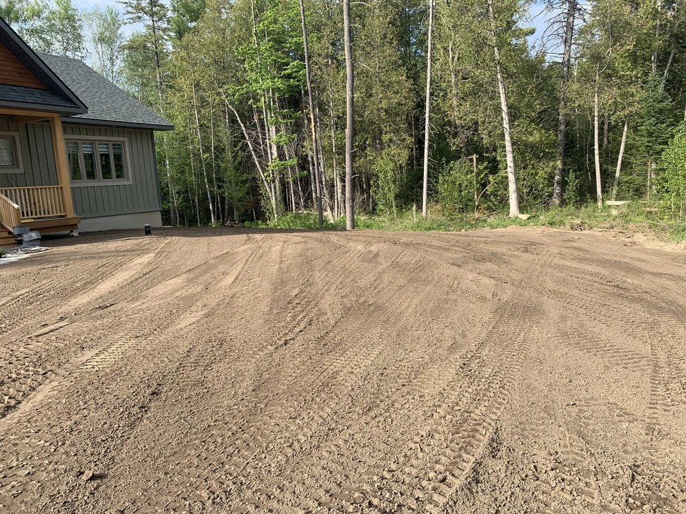 Graded and cleared yard beside a new house