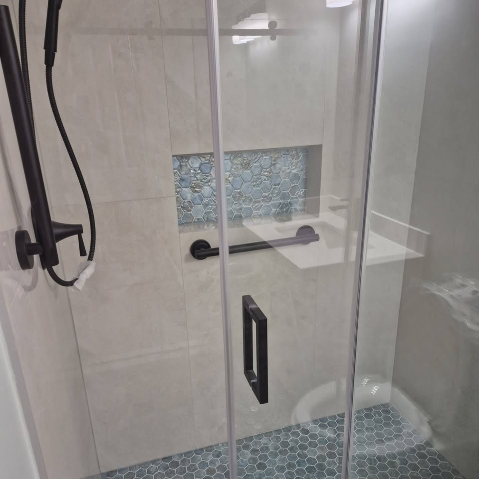Finished shower with large-format tile and blue hex mosaic
