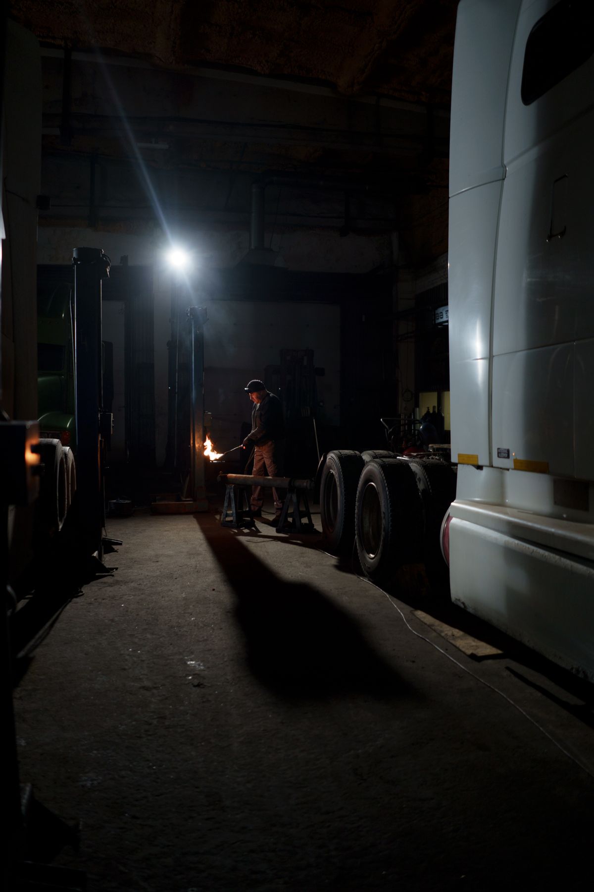 Welder working on a metal frame outdoors