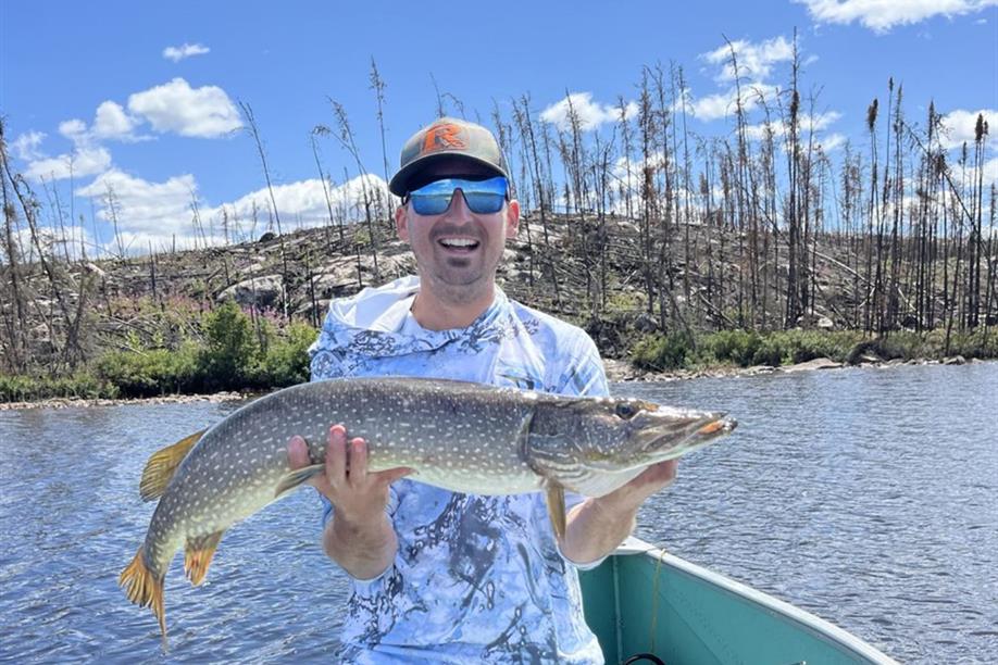 Angler holding a northern pike