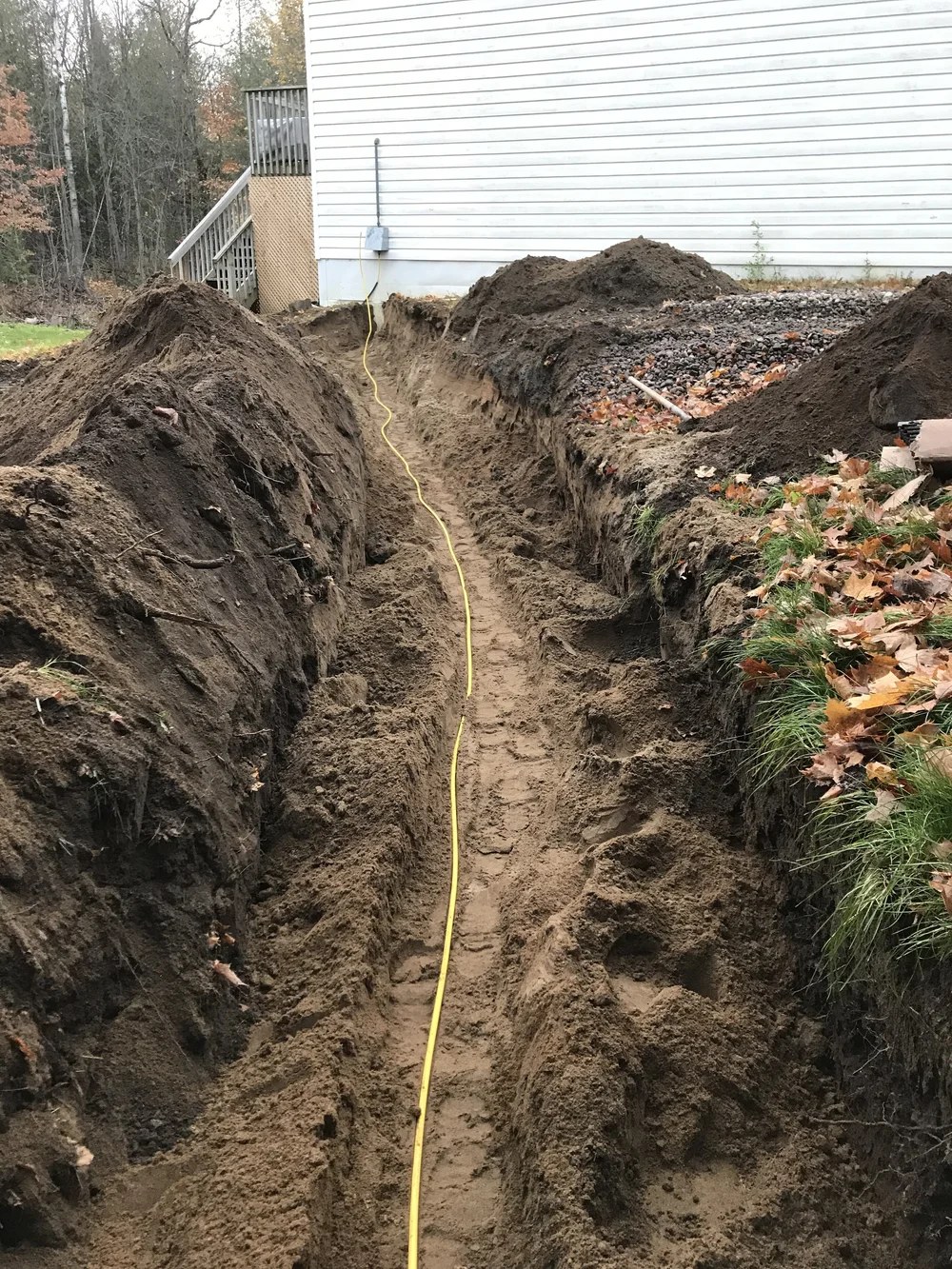 Utility trench beside a house
