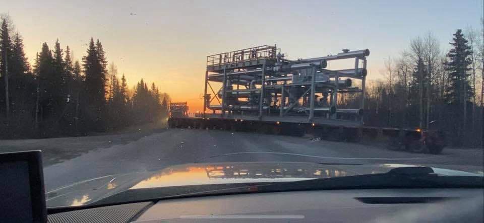 Oversize industrial module on a flatbed at sunset