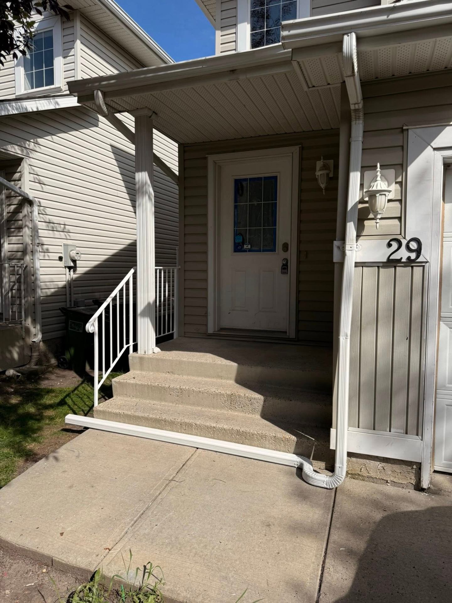 Finished home entry with a new white railing