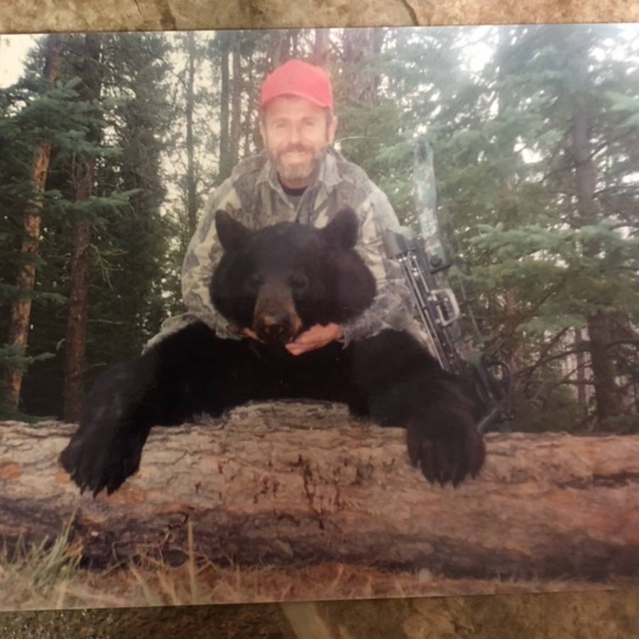 Bowhunter with a black bear