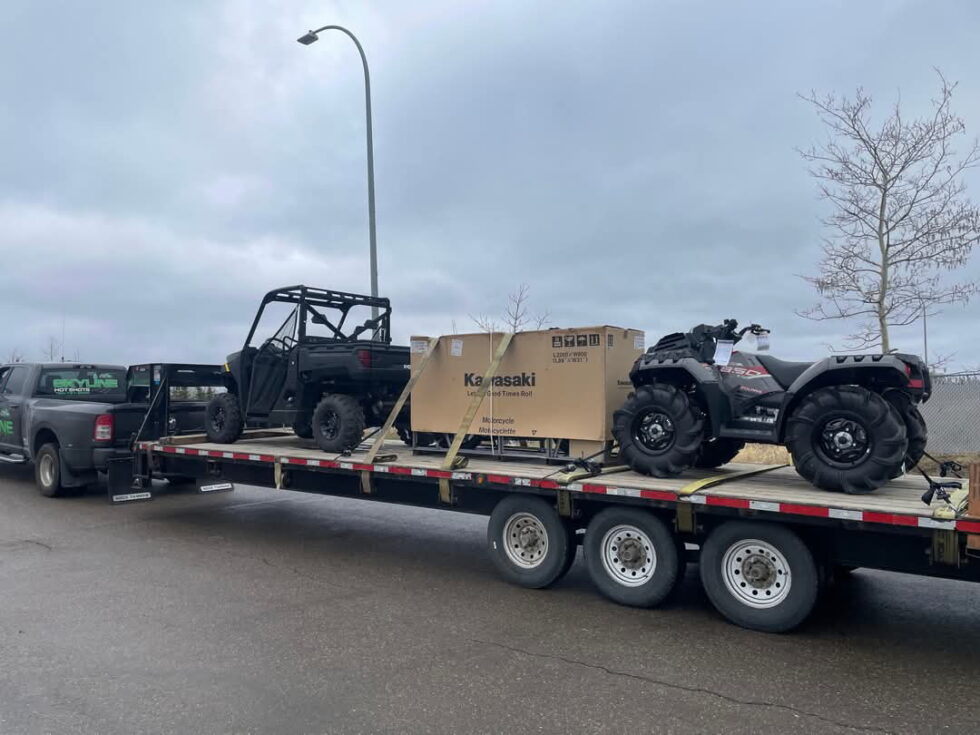 Flatdeck loaded with a UTV, ATV and motorcycle