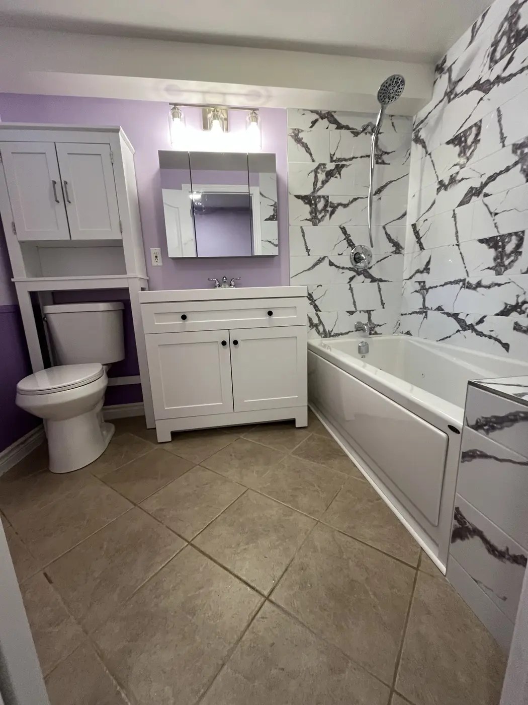 Finished bathroom with marble-look tile