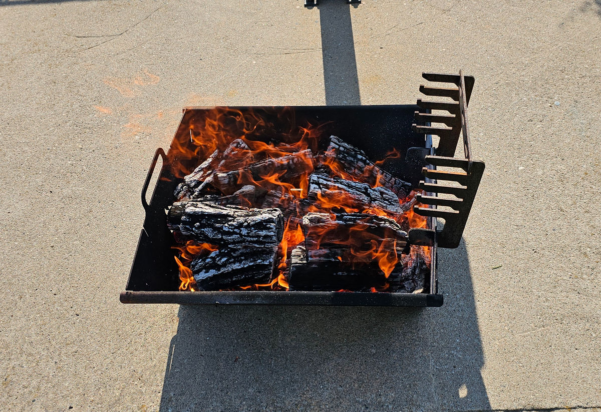 Steel fire pit with a fire burning