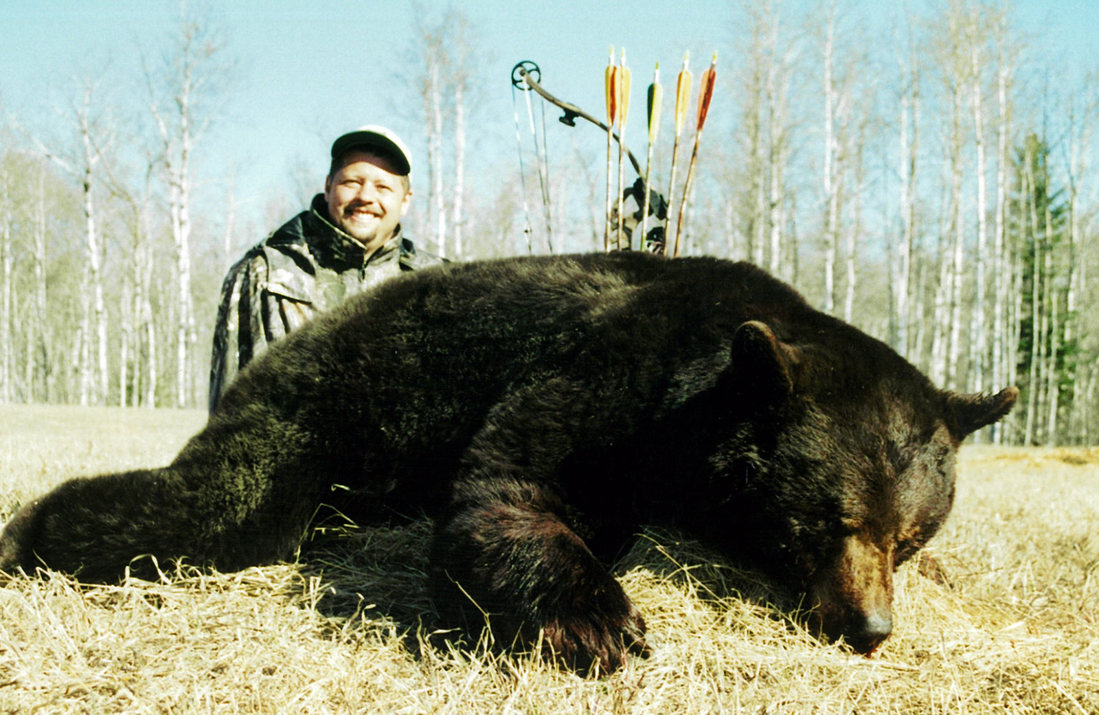 Hunter with a whitetail in a snowy field