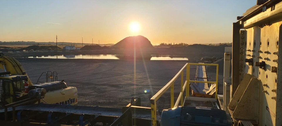 Sunrise over the gravel pit and crusher at Duane Saunders Co. in Sundre
