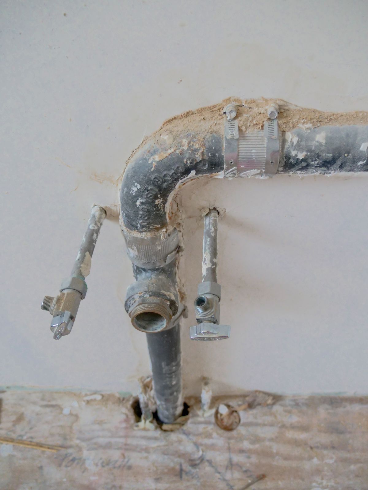 Plumbing pipes and shut-off valves in a wall