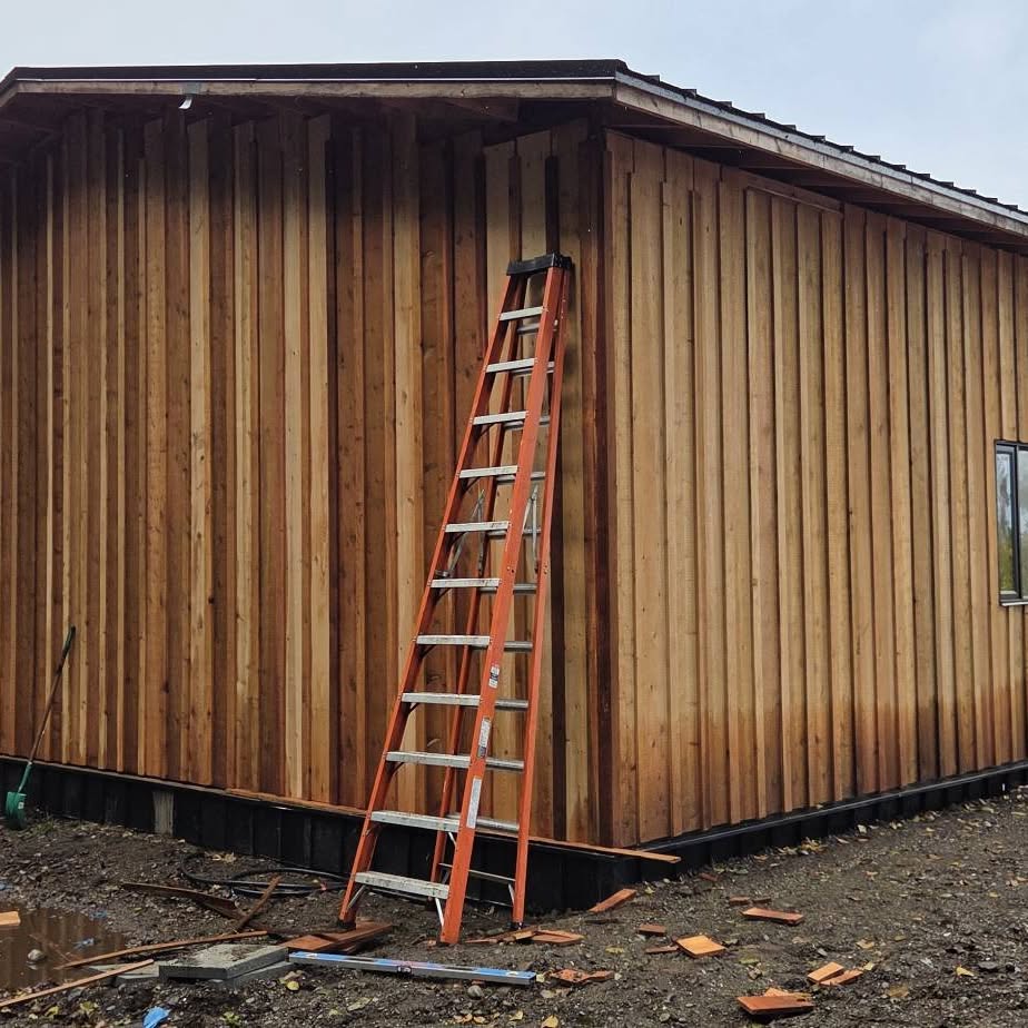 New cedar board-and-batten garage with two overhead doors